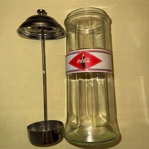 Coca-Cola heavy straw dispenser with chrome lid.